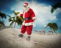 Santa Claus with snowboard in a beach Royalty Free Stock Photo