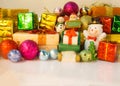 Santa Claus and snowman dolls deliver good kids gifts on Christmas eve, background with decorated Christmas present boxes, tree