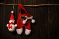 Santa Claus and snowman haning on dark wood wall Royalty Free Stock Photo