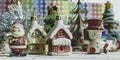 Santa Claus, snowman, houses and snow Sledge miniature model studio shot on colorful background for family, season, Christma Royalty Free Stock Photo