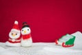 Santa claus, snowman wool doll and greed sled on snow set up wit Royalty Free Stock Photo