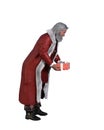 Santa Claus standing and bending with a Christmas present in his hands ready to give to a child. Isolated 3d illustration