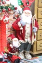 A santa claus standing next to a fireplace