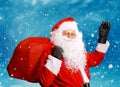 Santa Claus standing in the snow with a bag of gifts . Snowy landscape.Winter background .Merry Christmas and happy New Year Royalty Free Stock Photo