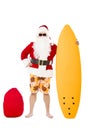 Santa Claus standing with surf board Royalty Free Stock Photo