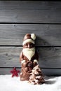 Santa claus star shaped christmas decoration chocolate christmas tree on heap of snow against wooden background Royalty Free Stock Photo