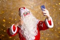 Santa claus takes selfie photos. Christmas night. Delivery of gifts. Enchanted Royalty Free Stock Photo