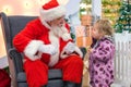 Santa Claus talking with little girl in Shopping Mall. Christmas wishes. 13dec2019 St-Petersburg Russia