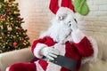 Santa Claus talking on mobile phone at home during Christmas Royalty Free Stock Photo