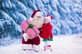 Santa Claus talking to little girl in snowy park Royalty Free Stock Photo