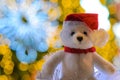 Santa claus teddy bear eyes who wearing hat sitting in front of colorful bokeh lights Royalty Free Stock Photo