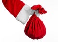 Santa Claus theme: Santa holding a big red sack with gifts on a white background Royalty Free Stock Photo