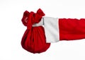 Santa Claus theme: Santa holding a big red sack with gifts on a white background Royalty Free Stock Photo