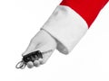 Santa Claus theme: Santa's hand holding the keys to a new car on a white background Royalty Free Stock Photo