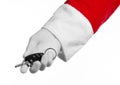 Santa Claus theme: Santa's hand holding the keys to a new car on a white background Royalty Free Stock Photo