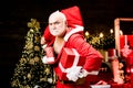 Santa Claus thief with a bag of christmas gifts. Thief Santa with bag on christmas background. Best prices for winter