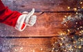 Santa Claus thumb up gesture over Christmas wooden background Royalty Free Stock Photo