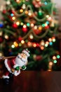 Santa Claus toy brings Christmas tree at blue snowy night bokeh Royalty Free Stock Photo