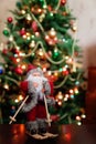 Santa Claus toy brings Christmas tree at blue snowy night bokeh Royalty Free Stock Photo