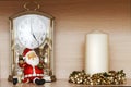 Santa claus toy, clock with a pendulum and christmas white candle with decoration