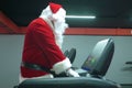 Santa Claus training at the gym on Christmas Day. Santa Claus running in machine treadmill at fitness gym club. Royalty Free Stock Photo