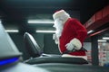 Santa Claus training at the gym on Christmas Day. Santa Claus running in machine treadmill at fitness gym club. Royalty Free Stock Photo