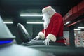 Santa Claus training at the gym on Christmas Day. Santa Claus running in machine treadmill at fitness gym club. Royalty Free Stock Photo