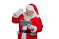 Santa Claus using computer tablet. Royalty Free Stock Photo