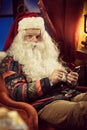 Santa Claus using smartphone Royalty Free Stock Photo