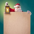 Santa Claus with vintage lantern and a poster Royalty Free Stock Photo