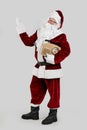 Santa Claus with vintage radio on grey background. Christmas music Royalty Free Stock Photo