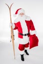 Santa Claus walking with sack and wooden skis Royalty Free Stock Photo