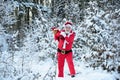 Santa Claus walking to the winter forest with a bag of gifts, snow landscape. Happy New Year. Postcard, greeting card. Royalty Free Stock Photo