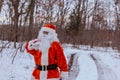 Santa Claus in the winter forest the carrying Merry Christmas present gifts for the new year