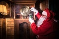 Santa Claus having a rest in a comfortable chair near the fireplace at home Royalty Free Stock Photo