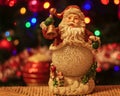 Santa Claus on a wooden Surface with christmas tree on background Royalty Free Stock Photo