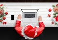 Santa Claus work on laptop computer with isolated screen for mockup Royalty Free Stock Photo