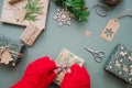 Santa Claus wrapping Christmas gift. Merry Christmas concept, Top view of Santa claus hands wrapping a craft gift box Royalty Free Stock Photo