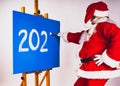 Santa Claus writes the numbers 2024 on the blue background