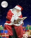 Santa Claus writing his notebook on the roof of a