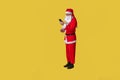 Santa claus yellow funny big, have a holiday of the year senior, fashionable caucasian costume, celebrate with phone in