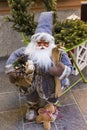 Santa Clause figurine equipped with sky`s and presents and a ginger man figurine Royalty Free Stock Photo