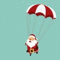 Santa clause is parachuting in the air. Christmas ornament.