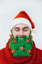 Santa Clause in red clothes with green beard smiles