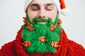 Santa Clause in red clothes with green beard smiles