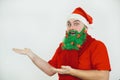 Santa Clause in red clothes with green beard smiles