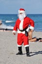 Santa Claus on a beach walking