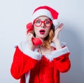 Santa Clous girl with eyeglasses and handset