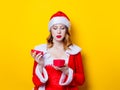 Santa Clous girl in red clothes with gift box