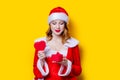 Santa Clous girl in red clothes with gift box
